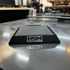 A black Starlink dish mount branded with 'HSM', placed on a metal surface, with the logo 'High Speed Mounts' visible.